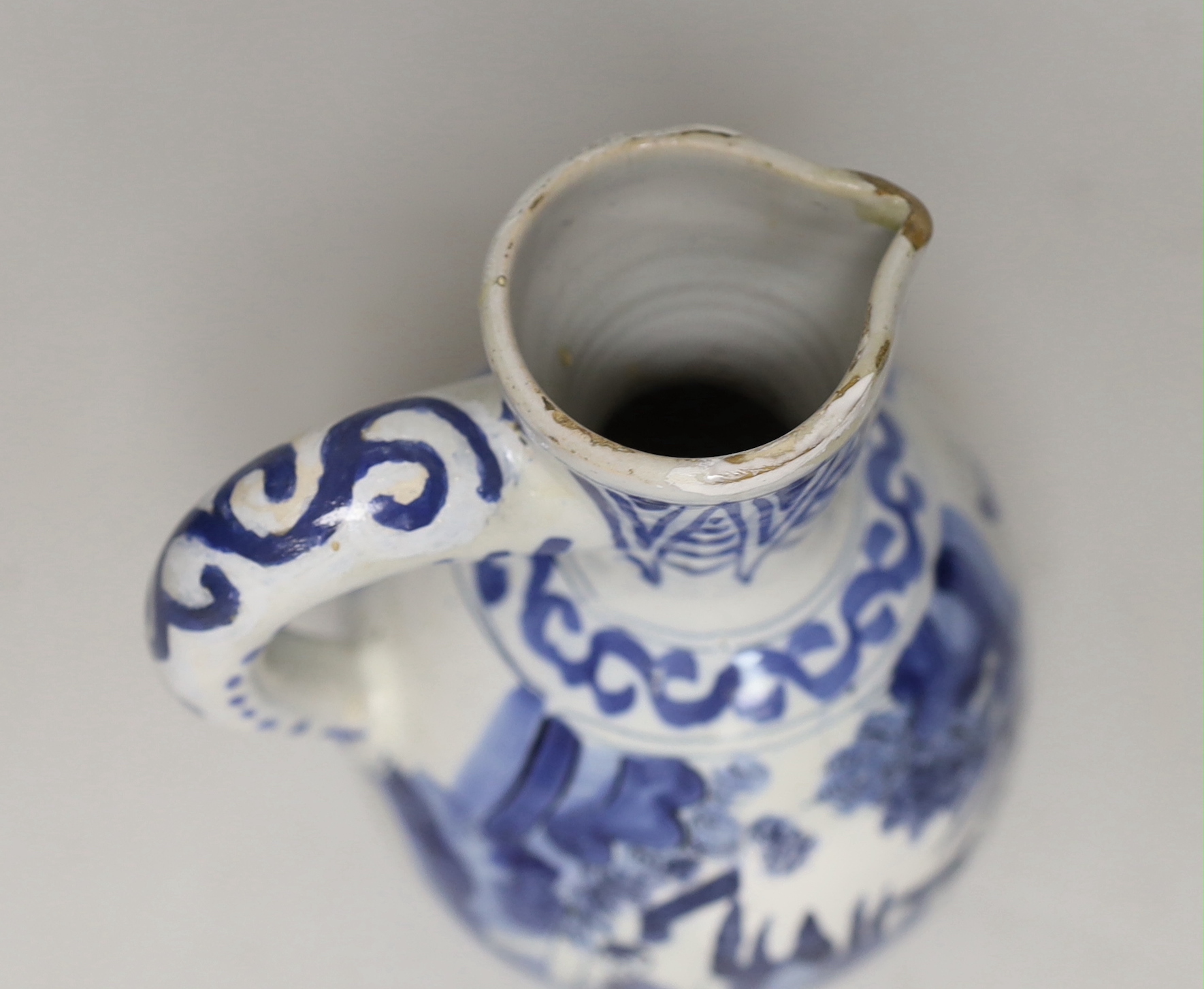 A late 17th century Delft blue and white ewer and three Chinese style tumblers and saucers, tallest 20cm